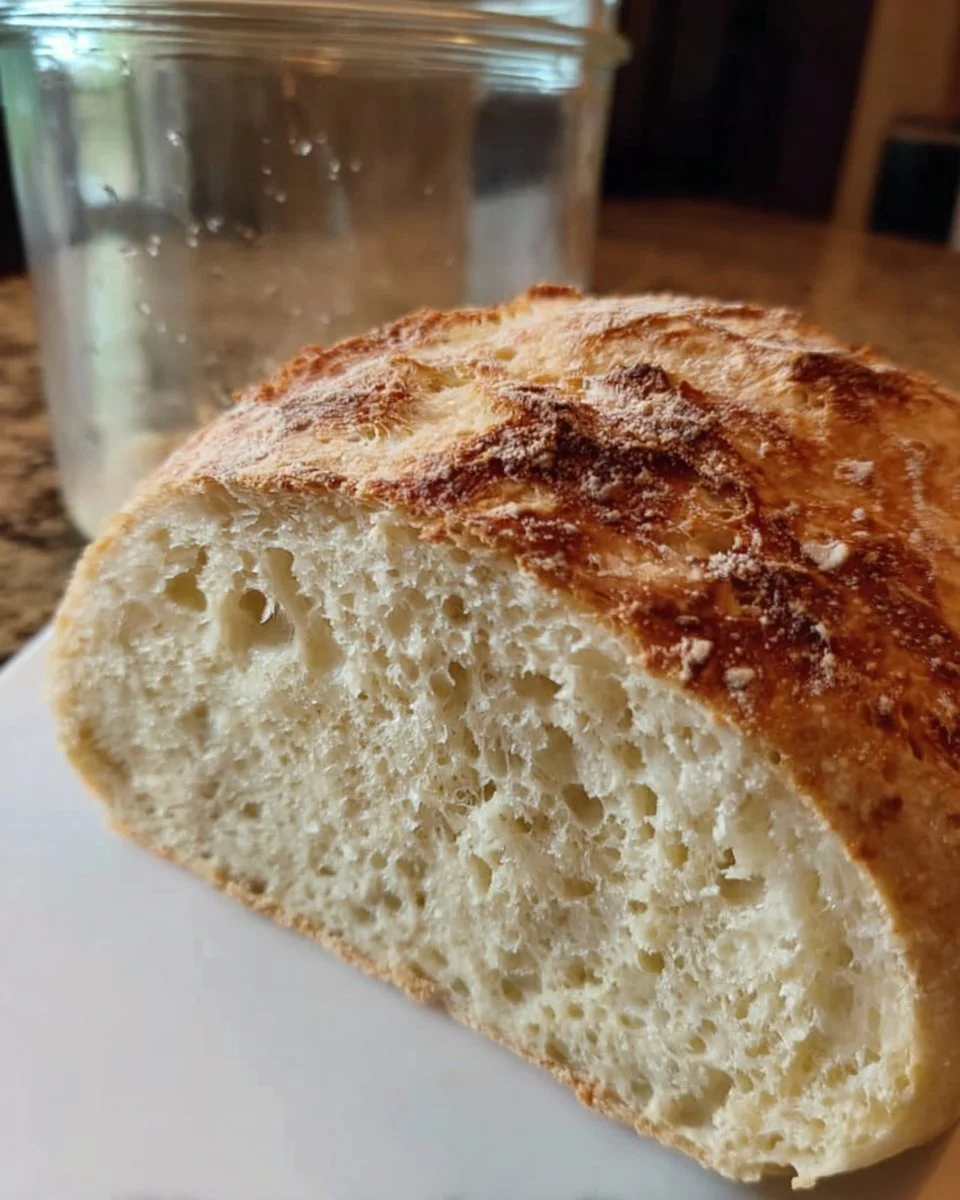 A jar of bubbling sourdough starter ready for baking delicious bread.